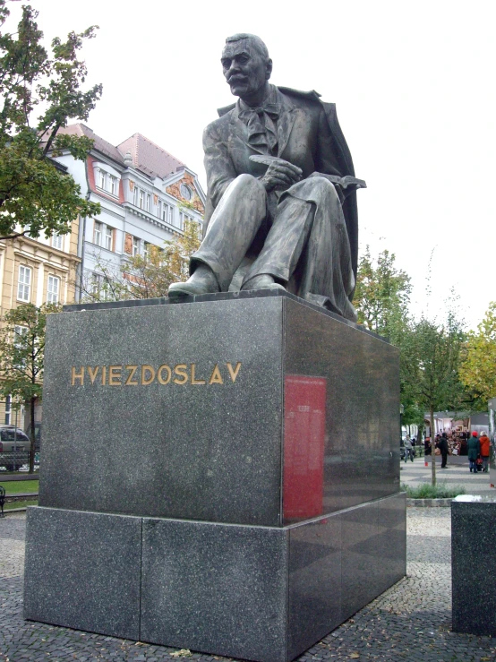 a statue in a small plaza with buildings around it