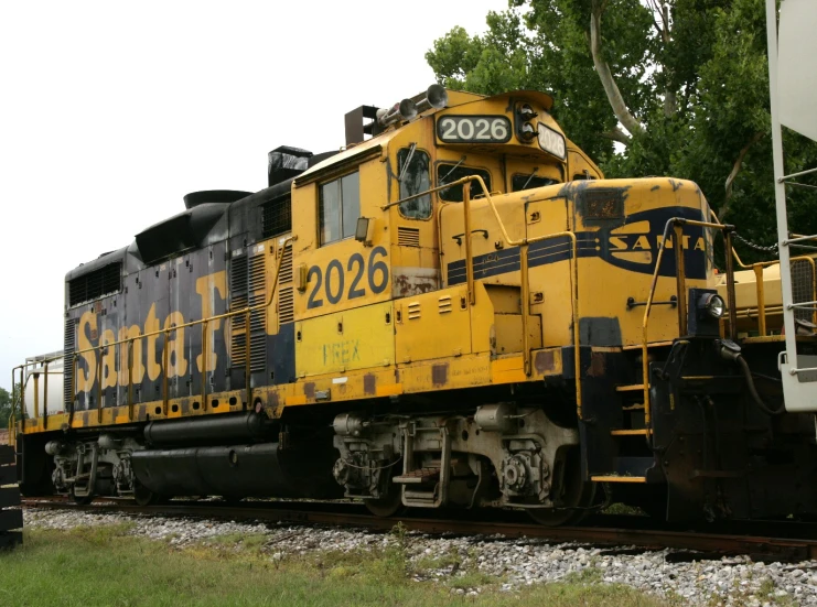 a locomotive engine sits on the tracks with the number 22 on the train cart