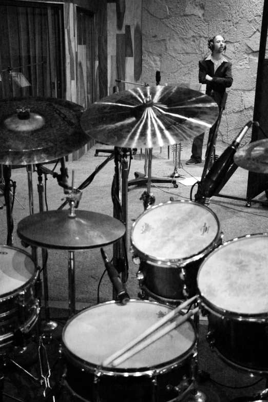 a group of drummers behind the drum set in a garage