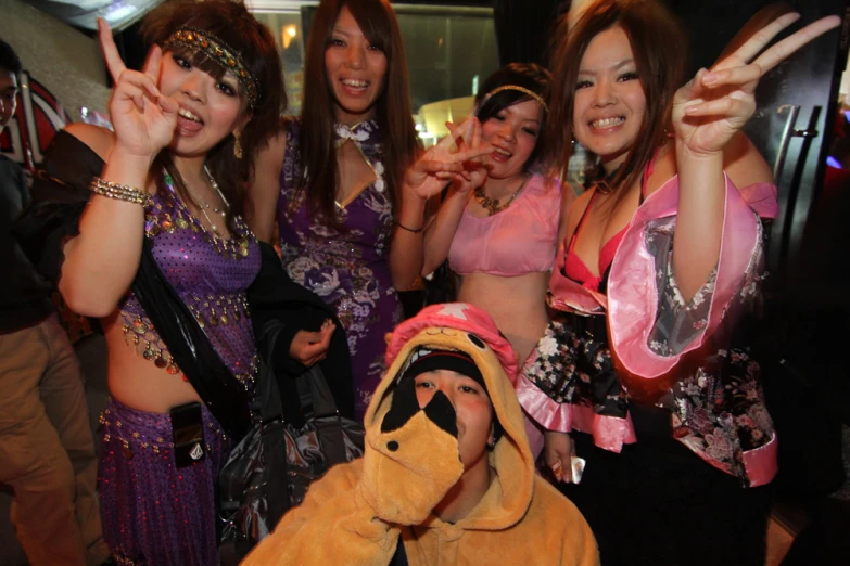 a group of women in costumes are posing for a po