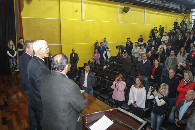 a large group of people are gathered at the podium