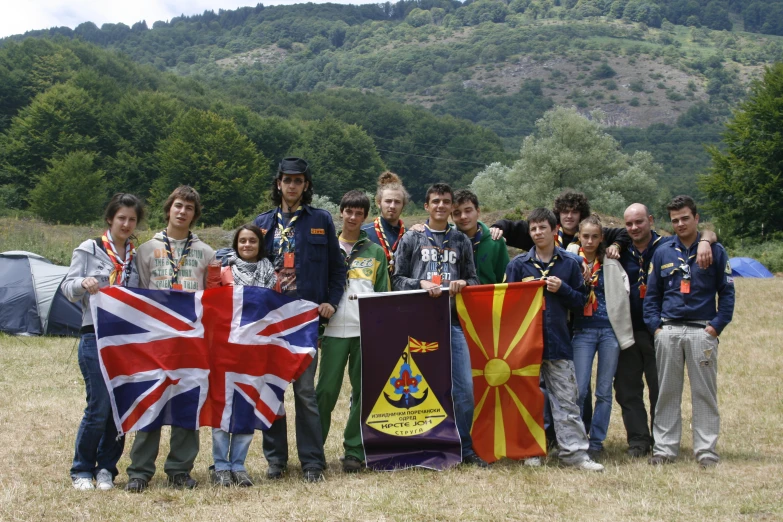 a group of people holding different flags near one another