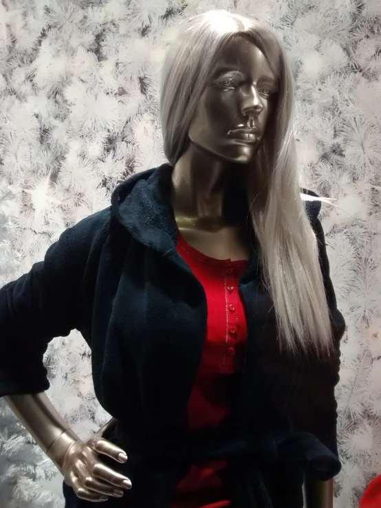 a mannequin with long blonde hair and red top