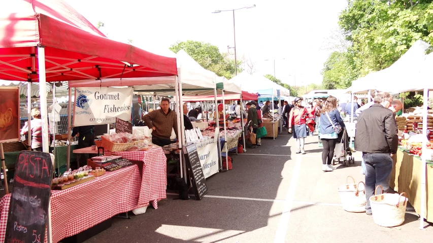 a group of people are browsing out the market