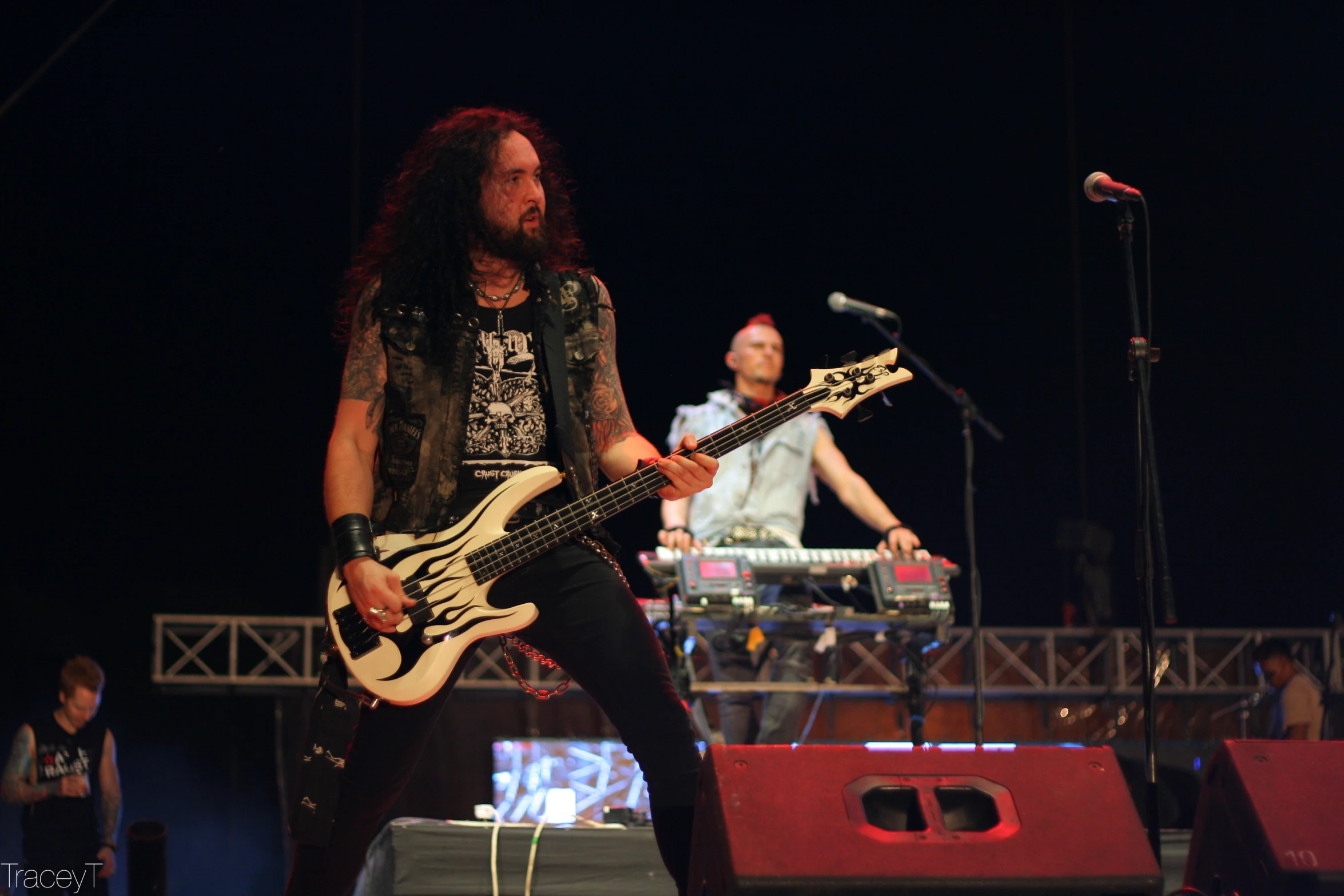 a man is holding onto a bass and standing on a stage