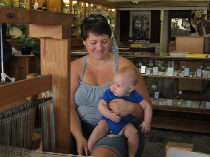 a woman with her child looking at a display in a store