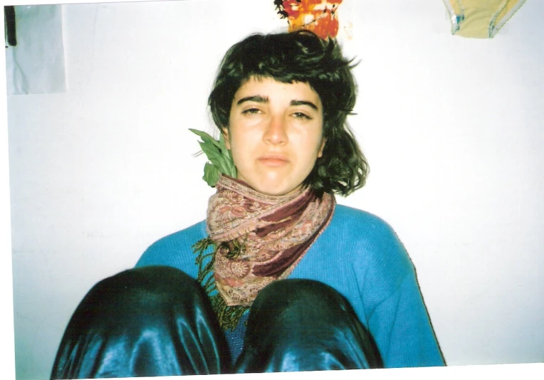 young man with messy hair and wearing a scarf