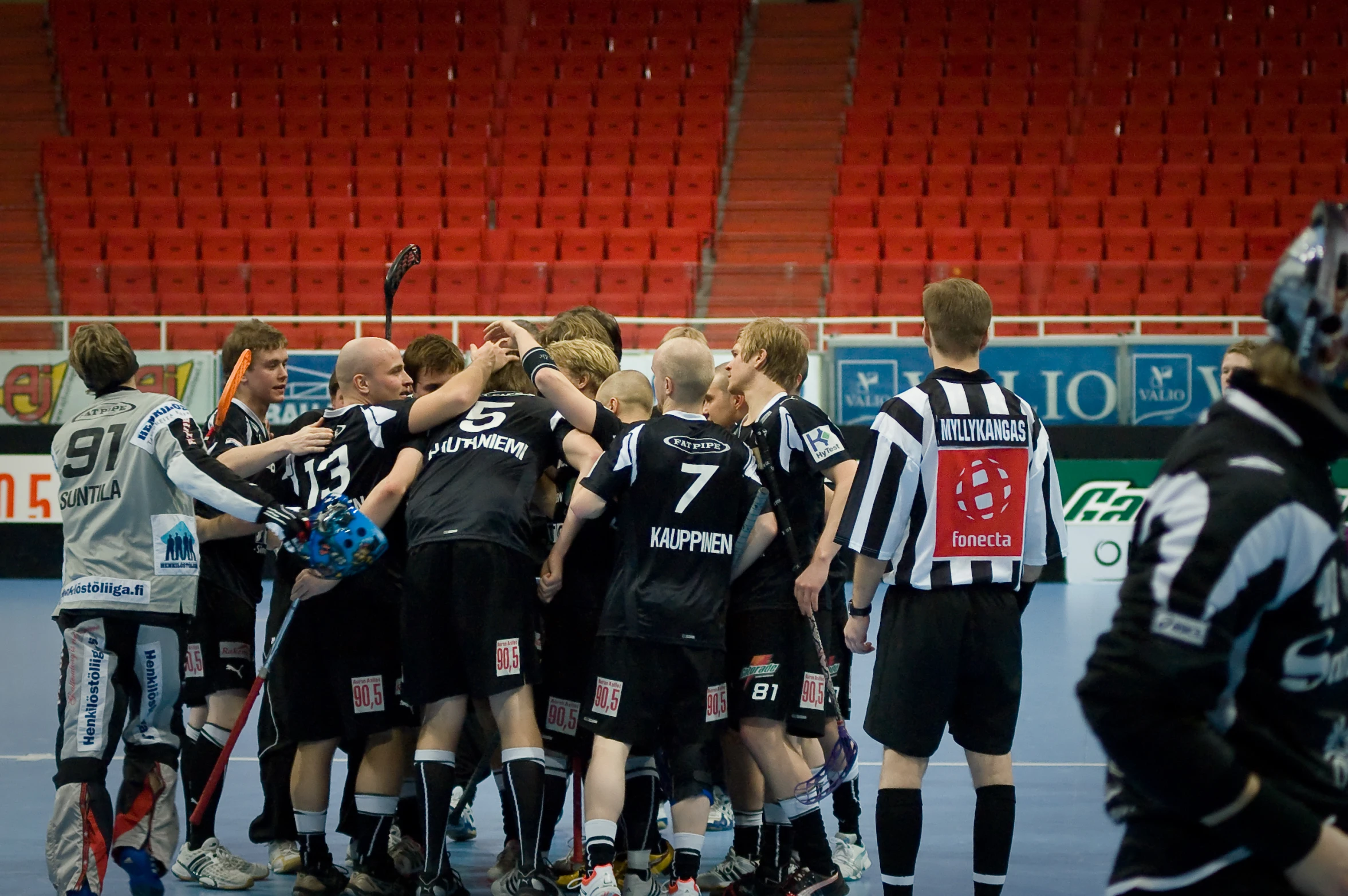 a group of men on a court playing field hockey