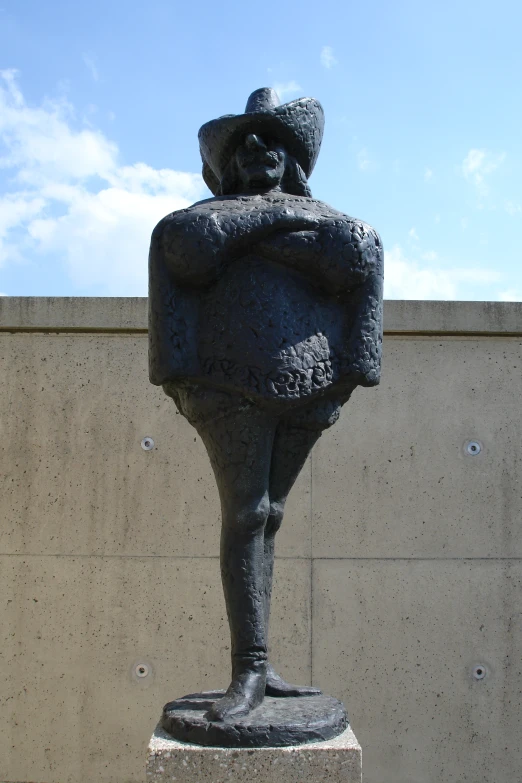 an iron statue on a stand holding soing