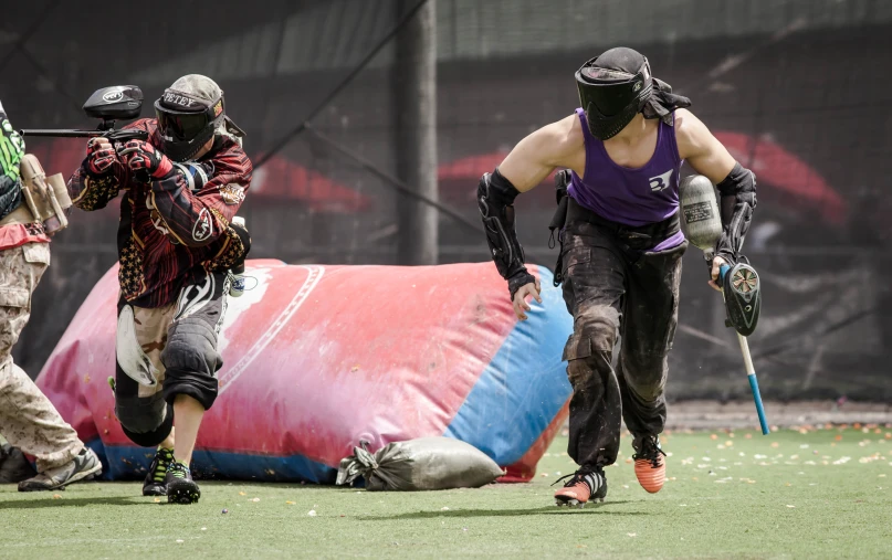 a group of people on a field with a flag and helmets