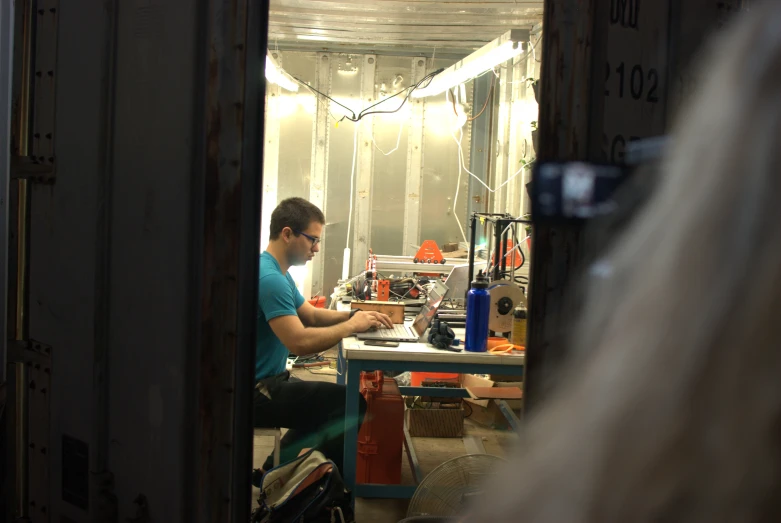 a man working in a workshop with various tools