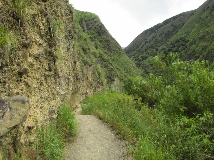 some very tall mountains with a very narrow pathway