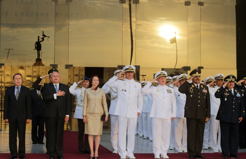 a large group of people in uniform posing for pictures