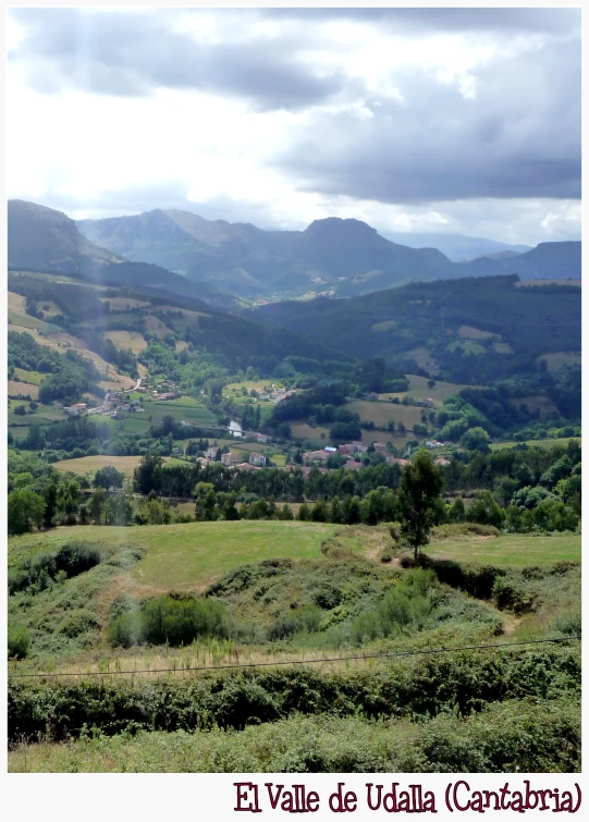 a scenic view of a small city in the mountains