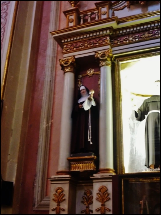 a statue of saint benedict in front of a window