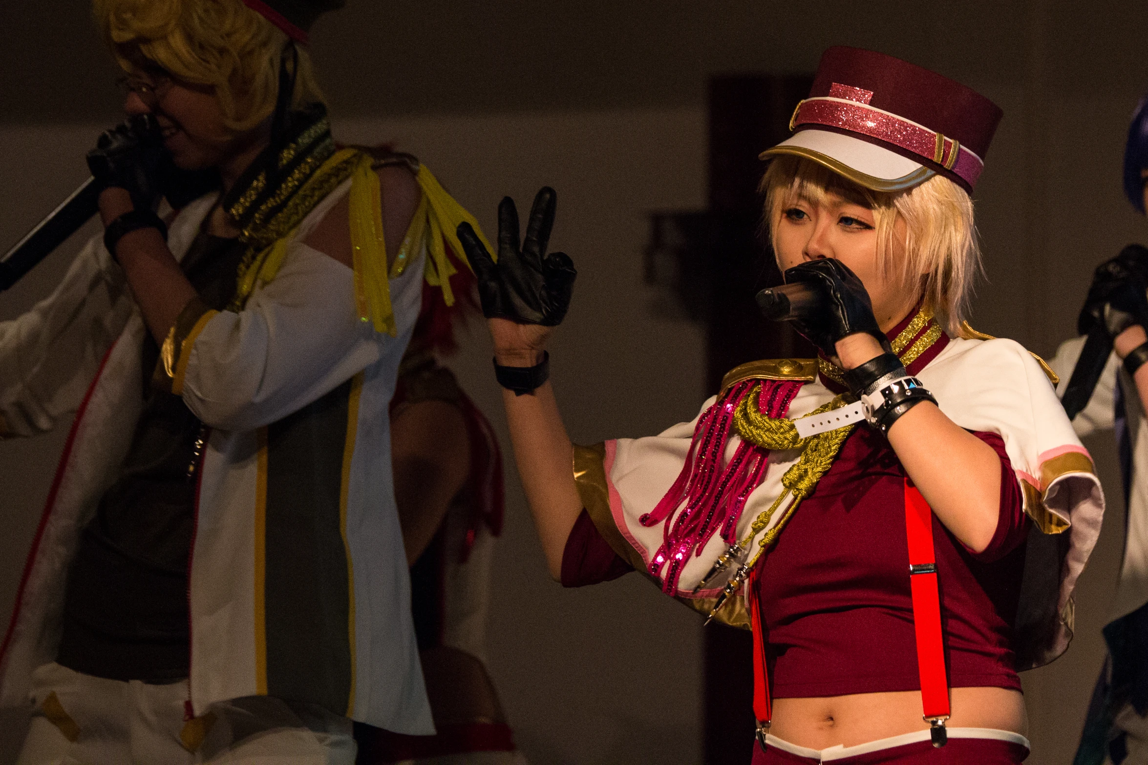 a woman singing into a microphone in a cosplay