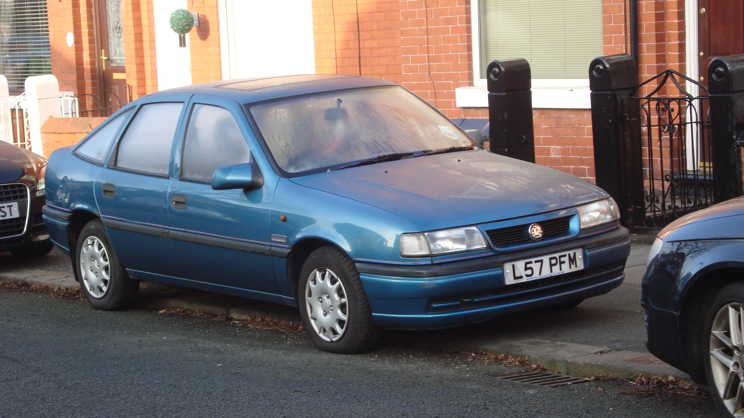 a blue car parked on the side of the street