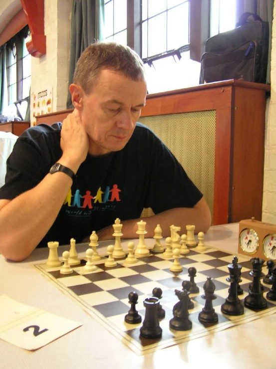 a man playing chess in a dining room