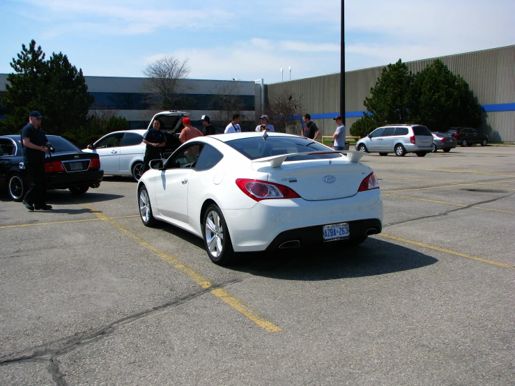 a car with a white body parked in a lot