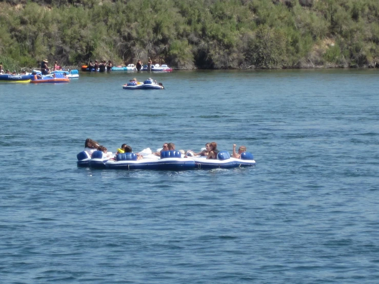 group of people in a blue speedboat out on the water