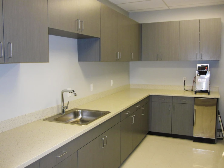 a kitchen with cabinets, a sink, and a dishwasher