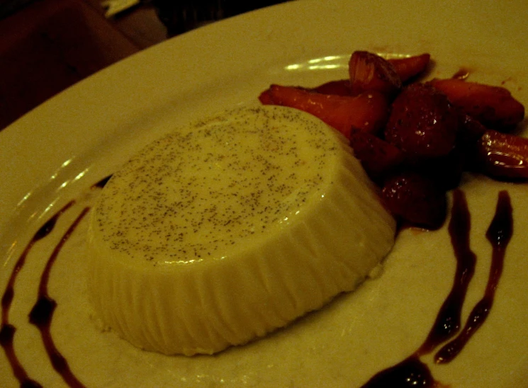 a dessert on a plate topped with strawberry slices