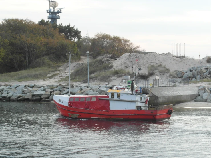 a boat docked in the harbor at low tide