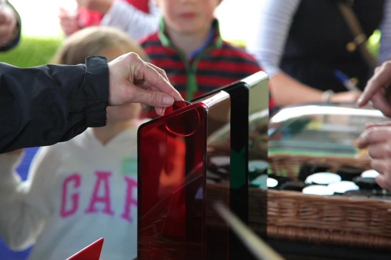 a person putting a ribbon on the inside of a large box