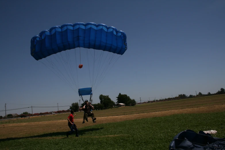 a group of people are riding their parachutes in the field