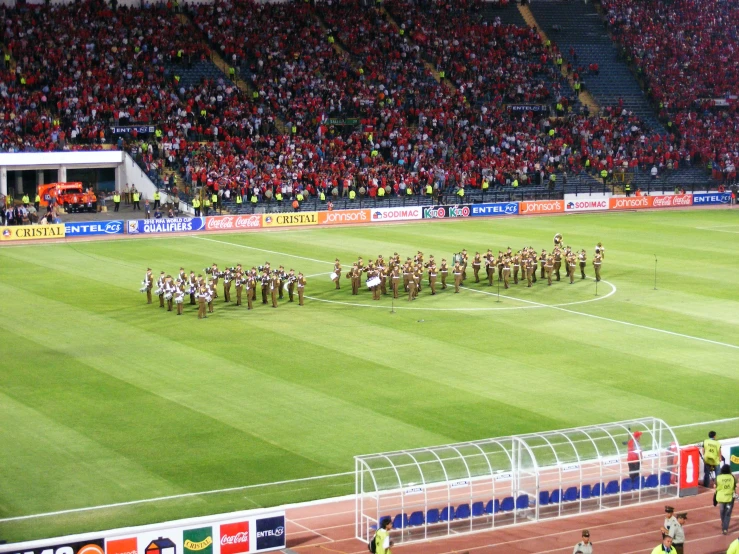 a team standing on the field of a soccer stadium