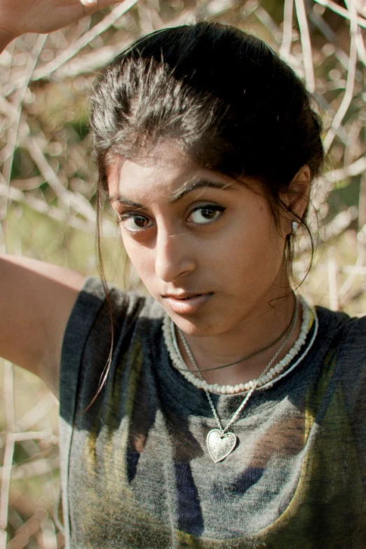 a girl is holding her hair in her hand