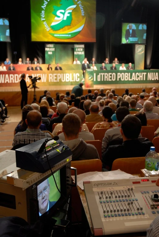 a conference room with people talking in a public conference