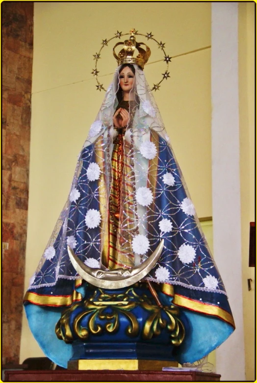 an elaborately decorated statue with a woman in gold and blue