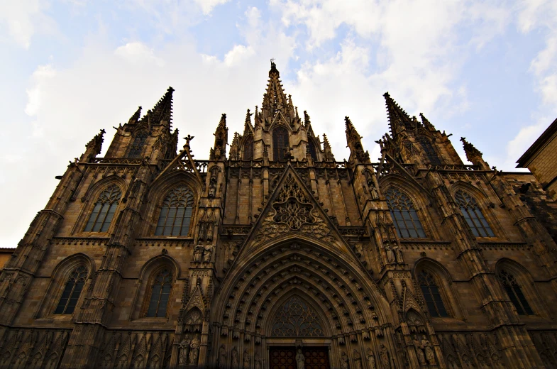 the front of an elaborate church with steeples and doors