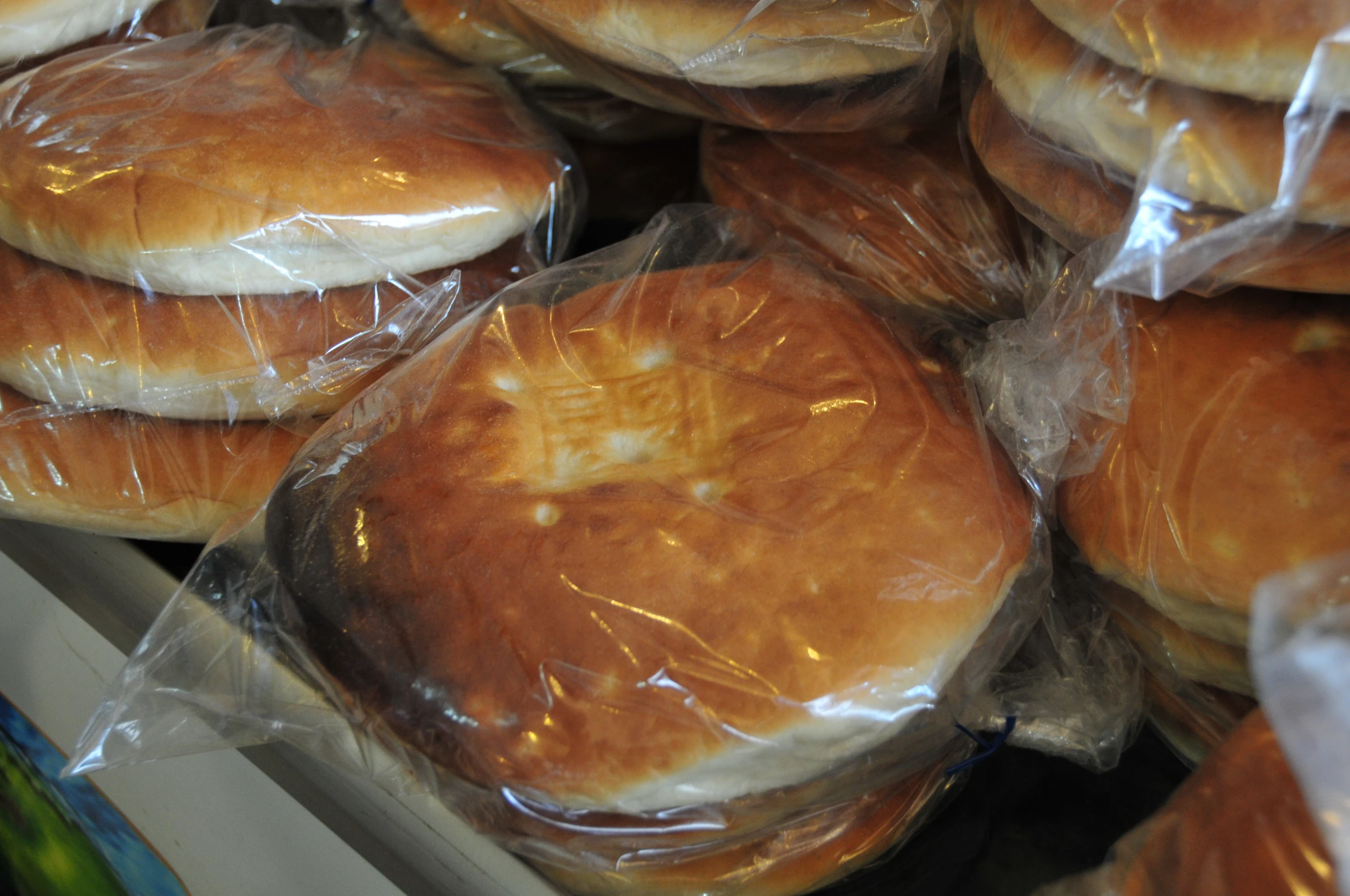 some fresh baked bread sitting on display in bags