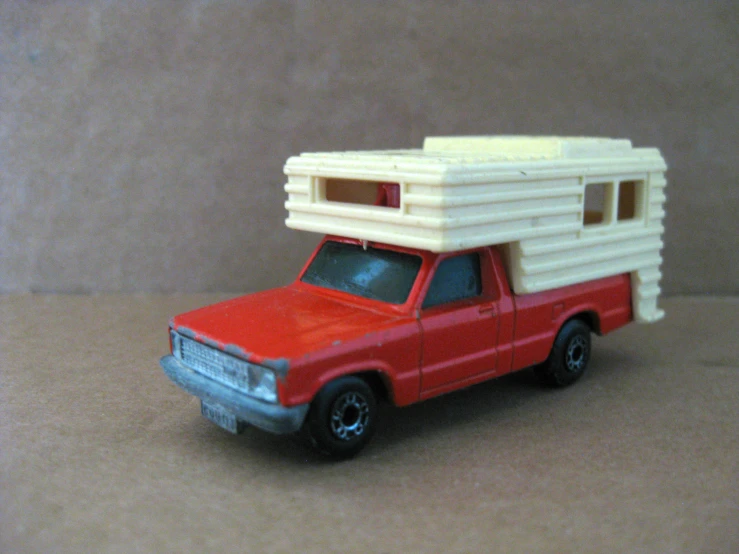 a red truck with a camper and roof rack on it