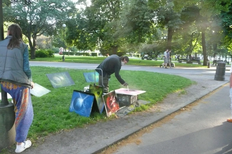 woman reaching for a tv on a box