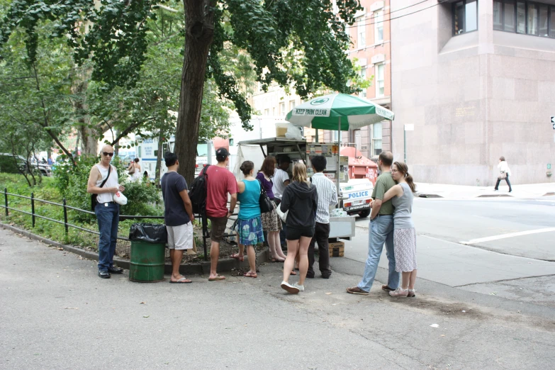 a group of people standing at a food truck