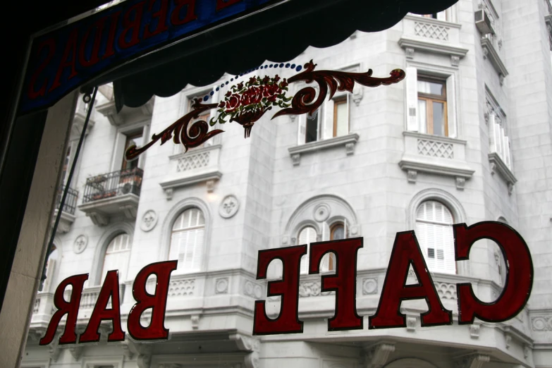 a large sign on a building says cafe bar