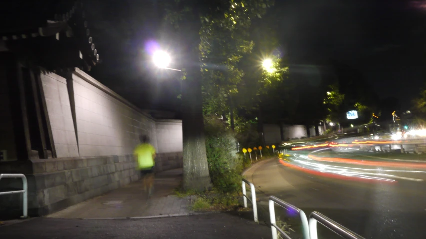 a blurred street with an illuminated streetlight on