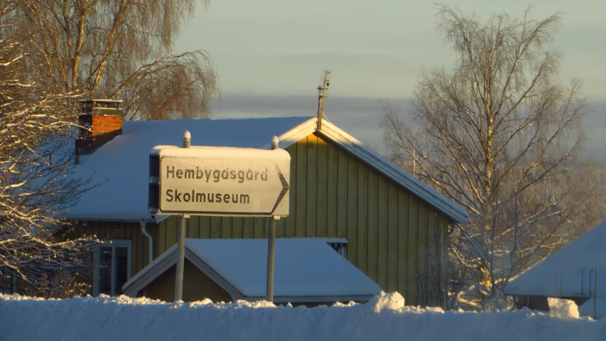 a green building with a large white sign in the front