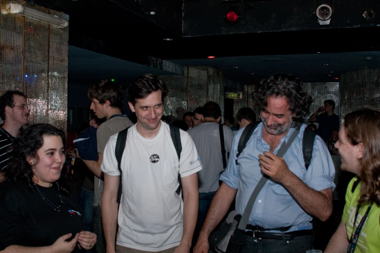 a crowd of people standing around at night