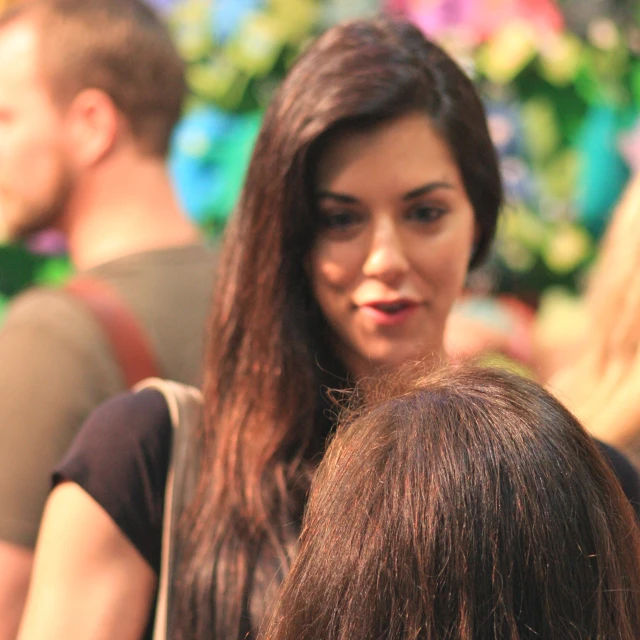 a girl standing with her hair down, looking away