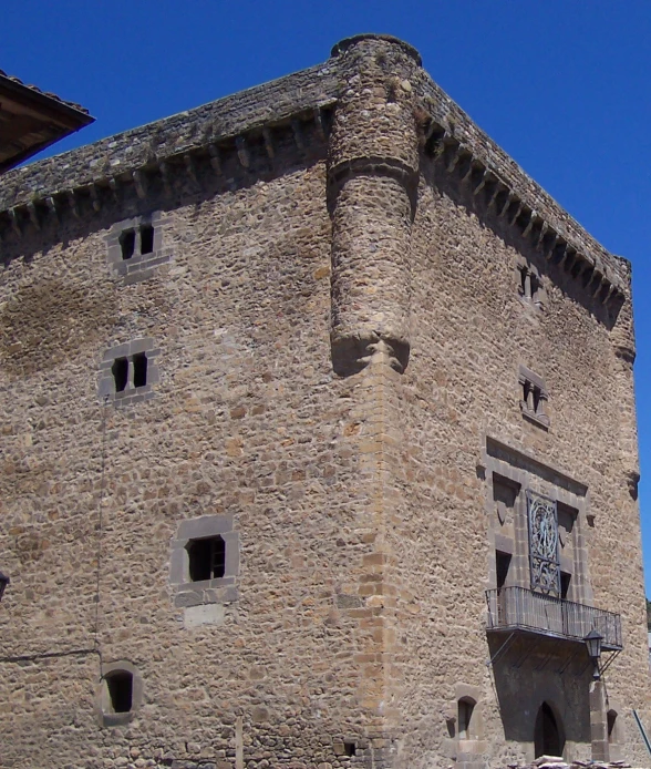 a clock on the side of a stone building