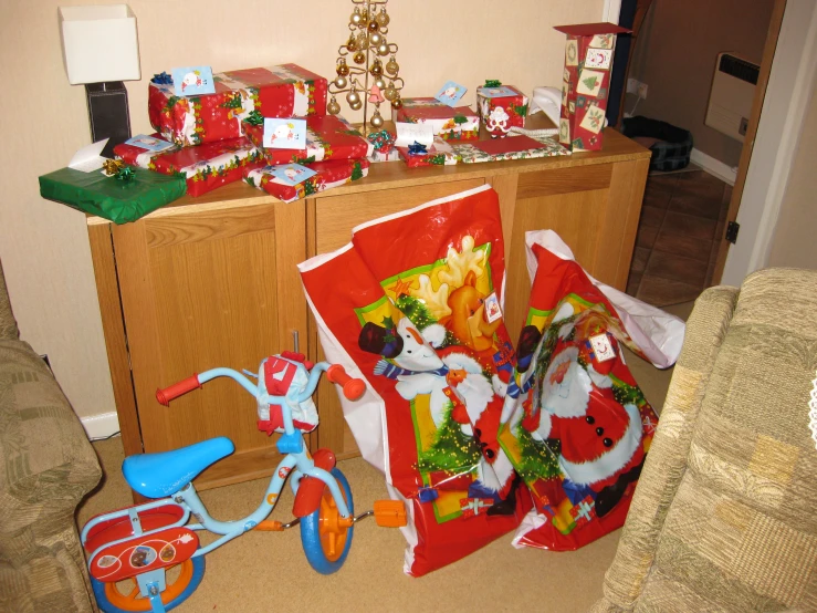 a bicycle sitting next to several different gift bags on a table