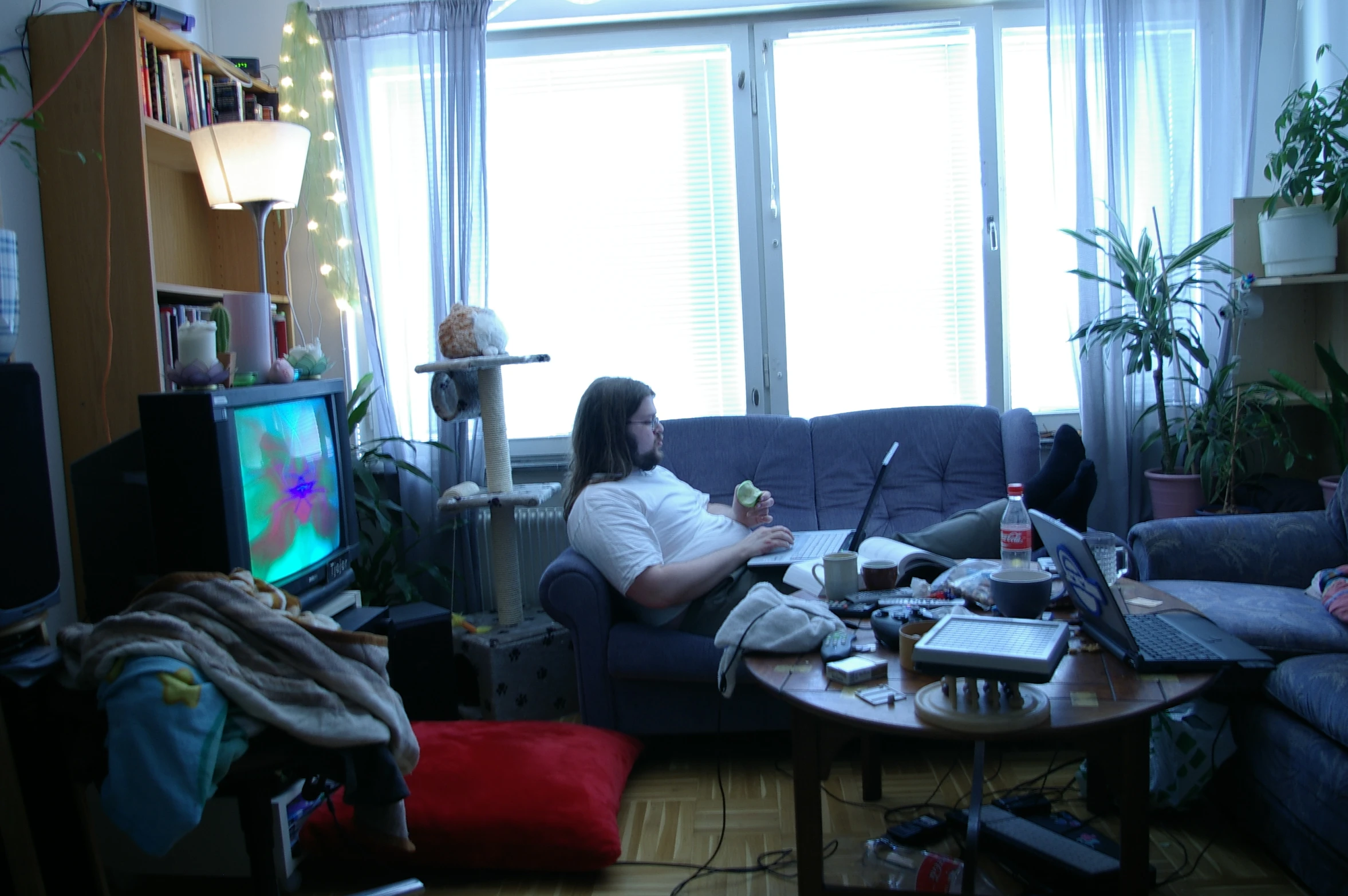 a man sitting on top of a couch in a living room