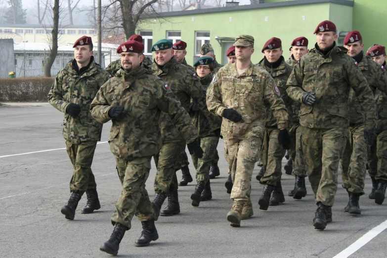 military personnel marching in formation on street