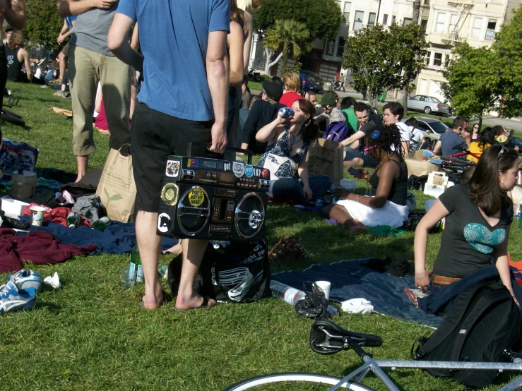 a group of people are on the grass by some bikes