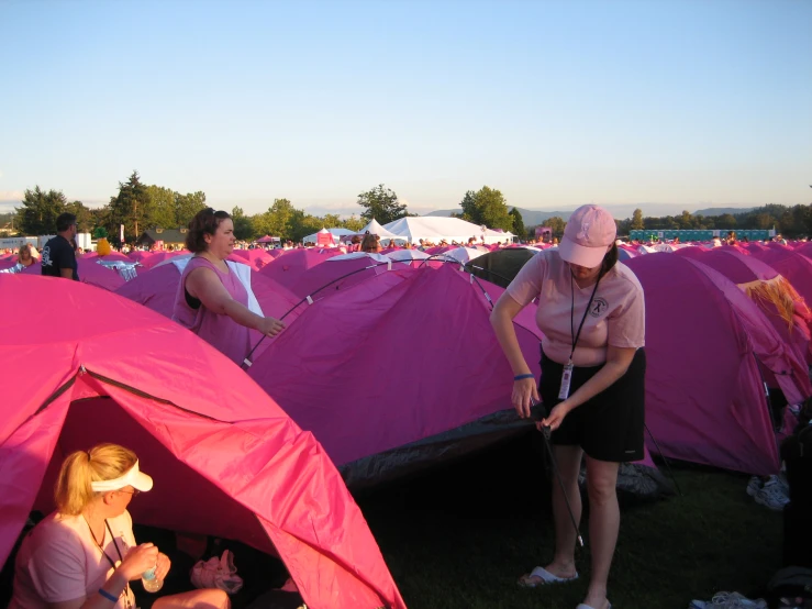 two women and one is standing in a tent