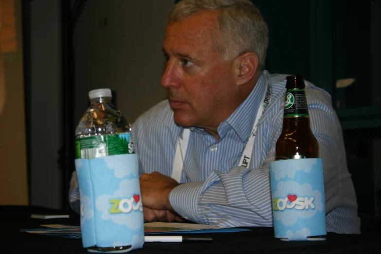 a man looks at two bottles of soft drinks